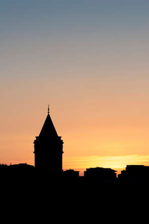 The Galata Tower in central Istanbul silhouetted against the sky at sunset.の写真素材