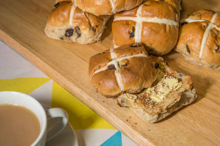 Hot cross buns with a cup of teaの写真素材