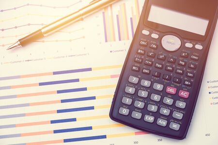 Calculator and pen for data analysis from charts and graph on desk office. business conceptの写真素材