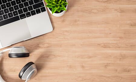 Laptop and headphone on wood office desk, top view, copy space, 3D renderingの写真素材