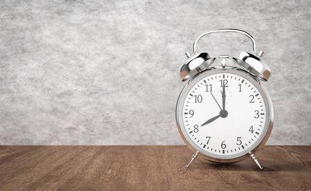 Alarm clock on wooden table and cement background, 3d rendering