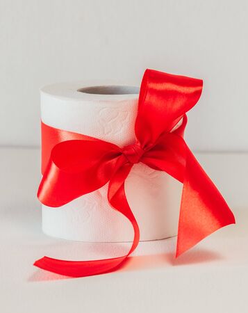 toilet paper with a red bow on a white background.の写真素材