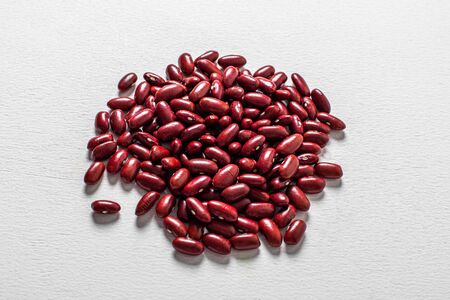 Red beans beautifully laid out circle on a white background. Vegetarian food. Unprepared.