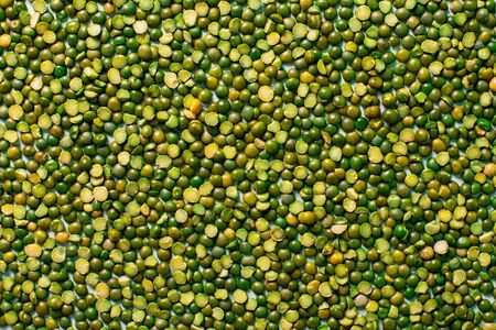 Green peas beautifully laid out. food background. Top view and copy space. Vegetarian food. Unprepared.の写真素材