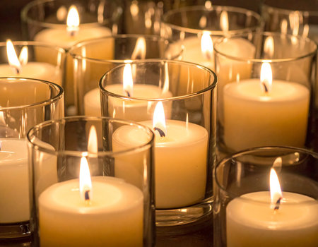 Warm glowing candles illuminate a peaceful scene creating a cozy atmosphere Ideal for relaxation and meditation conceptsの素材