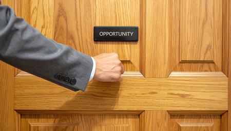 Businessman's hand is pressing a button on a wooden door.の素材