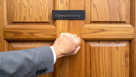 Businessman's hand knocking on a door with the word opportunity.の素材