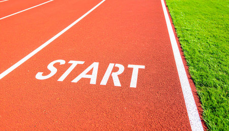 Start word on running track with green grass, sport and competition conceptの素材