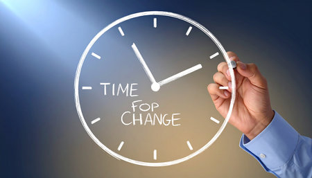 Time for change concept with a hand drawing a clock on a virtual screenの素材