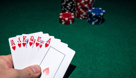 Playing cards and chips on green casino table. Gambling concept.の素材