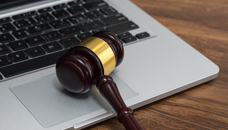 Wooden judge gavel and laptop on wooden table, law conceptの素材