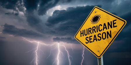 A yellow hurricane season sign stands against a dark, stormy sky with lightning. Clear details and vibrant co...の素材