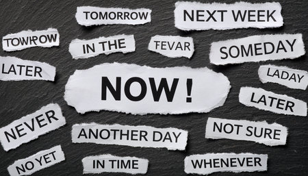 Torn paper strips with words like "NOW", "Tomorrow", "Later", "Never" on dark textured backgroundの素材