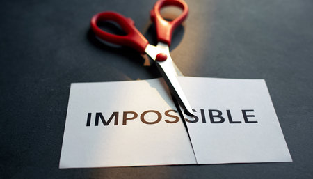 Red scissors are cutting a white paper strip with the word Impossible. Clear details and vibrant colors enhan...の素材