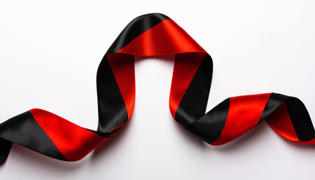 Red and black satin ribbon curled on a white background Clear details and vibrant colors enhance visual appeal.の素材