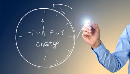 Businessman drawing a circular diagram with a marker on a transparent boardの素材