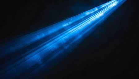 Blue rays of light on a black background. Abstract blue background.の素材