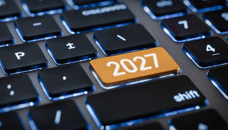 A close-up view of a backlit keyboard with the number 2027 on a golden key. Clear details and vibrant colors ...の素材