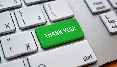 Close up of a green keyboard key with THANK YOU! on a silver computer keyboard Clear details and vibrant colo...の素材