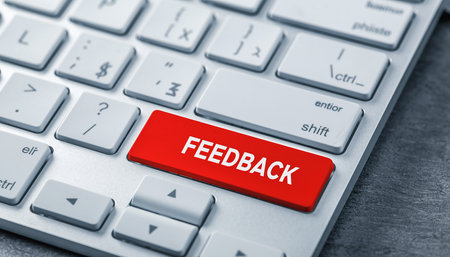 A red button labeled FEEDBACK is prominently displayed on a computer keyboard. Clear details and vibrant colo...の素材