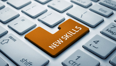 A computer keyboard with an orange button highlighted with the text "NEW SKILLS" Clear details and vibrant co...の素材