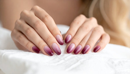 Female hands with pink nail design. Glitter pink nail polish manicure.の素材