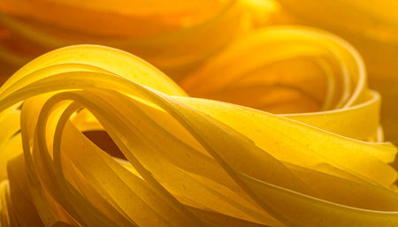 close up of yellow tagliatelle pasta for background or textureの素材