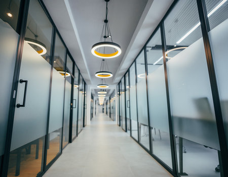 Interior of a modern office building with glass walls and long corridorの素材