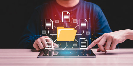 Close up of a man using tablet pc with file sharing concept on screenの素材