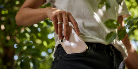 Close up of woman holding handbag in the park. Selective focus.の素材