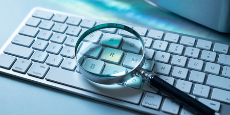 Magnifying glass on computer keyboard. Business and finance concept. 3D Renderingの素材