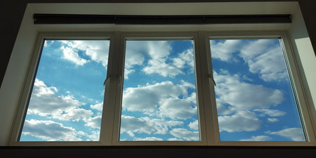 View from the window of a modern house with blue sky and cloudsの素材