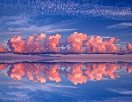 Beautiful sunset sky with clouds reflected in water. Nature composition.の素材