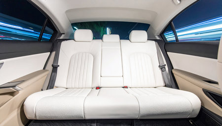 Luxury interior of a modern car with white leather seats.の素材
