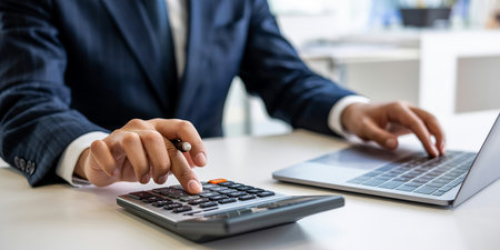 Accounting Calculating Mathematic Economic Finance Concept. Businessman Using Calculator.の素材