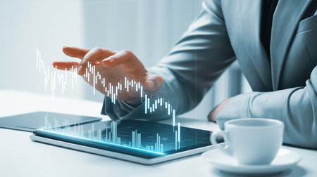 Person analyzing financial charts projected from a tablet. Clear details and vibrant colors enhance visual ap...の素材