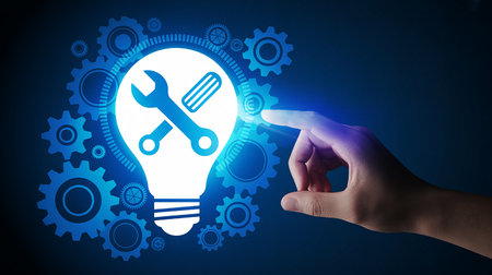 Hand touching a glowing lightbulb with tools and gears on a dark blue background Clear details and vibrant co...の素材