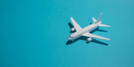 Airplane model on blue background. Travel concept. Minimal style.の素材