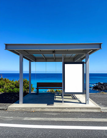 Bus stop with blank billboard in front of the ocean on a sunny dayの素材