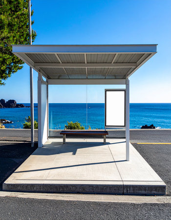 empty bus stop with blank billboard on the background of the sea and blue skyの素材