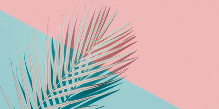 Tropical palm leaf on pastel background. Minimal summer concept.の素材