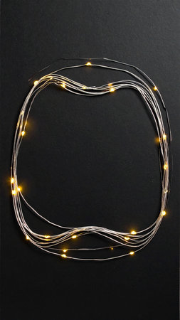 Christmas lights on a black background. Glowing garland on a black background.の素材