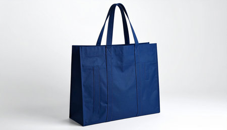 Blue shopping bag isolated on white background. 3D rendering. Front view.の素材
