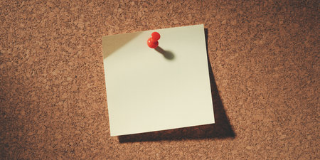 Blank sticky note pinned to cork board with red pushpinの素材
