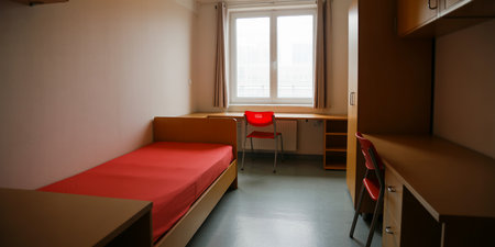 Interior of a hotel room with red bed and chairs. Nobody insideの素材