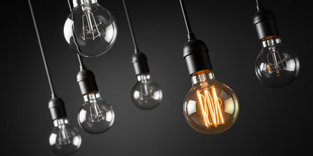 Group of vintage edison light bulbs on dark background. 3D renderingの素材