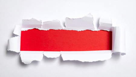 Torn paper with space for your message on a red background.の素材