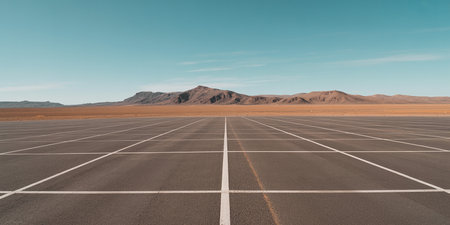 Empty asphalt road in the middle of the desert with mountains and blue skyの素材