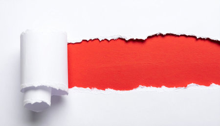 Torn paper with space for your message on a red background.の素材