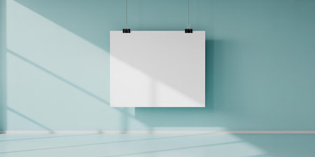 Blank white poster hanging on blue wall in empty room. 3D renderingの素材